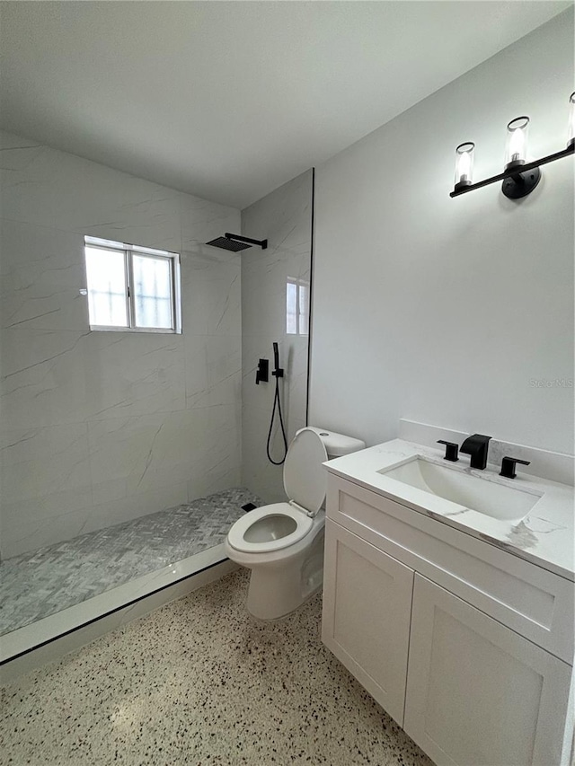 2921 SW 10th St Unit 23, Miami, FL 33135 - bathroom with a tile shower, vanity, and speckled floor
