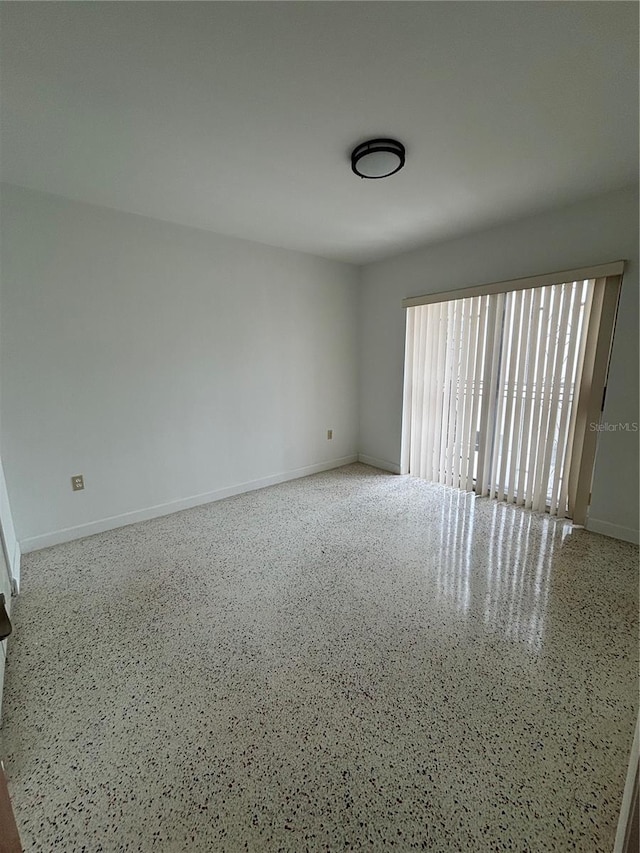 2921 SW 10th St Unit 23, Miami, FL 33135 - empty room featuring speckled floor and baseboards