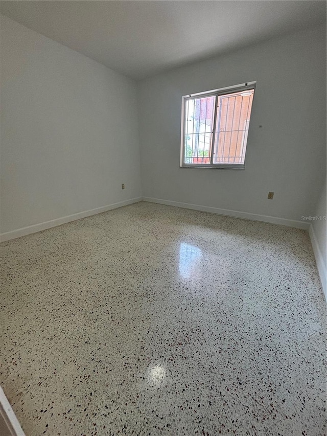 2921 SW 10th St Unit 23, Miami, FL 33135 - empty room with speckle patterned floor and baseboards