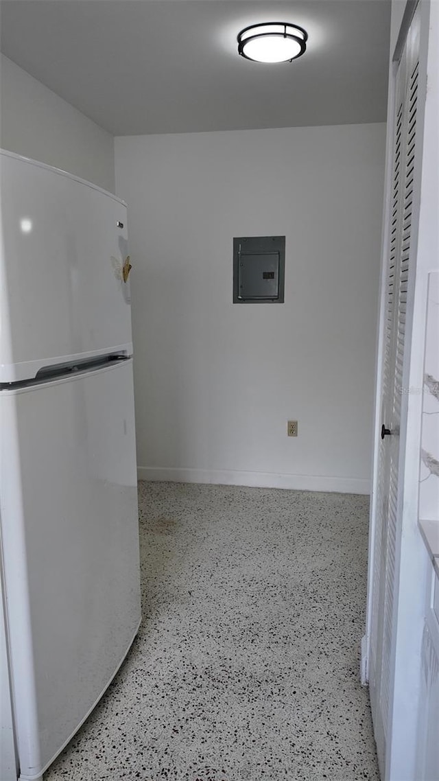 2921 SW 10th St Unit 23, Miami, FL 33135 - kitchen with freestanding refrigerator, electric panel, and speckle patterned floor
