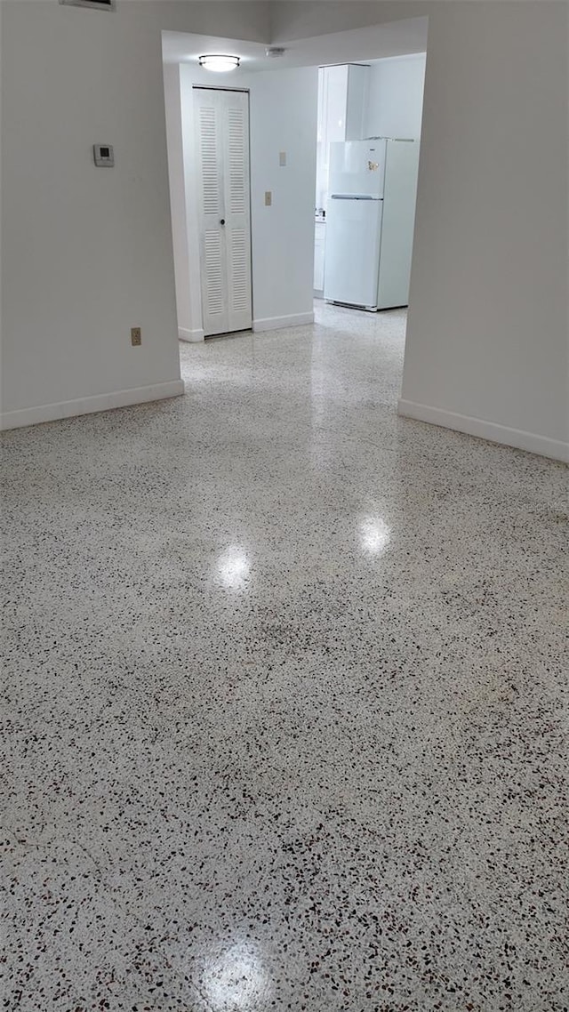 2921 SW 10th St Unit 23, Miami, FL 33135 - spare room featuring speckle patterned floor and baseboards