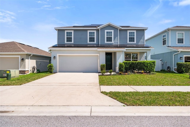 8595 Prairie Creek Dr, New Port Richey, FL 34655 - traditional-style home featuring driveway, a front lawn, roof mounted solar panels, and a garage
