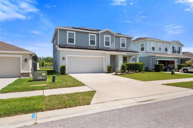 8595 Prairie Creek Dr, New Port Richey, FL 34655 - traditional-style house with roof mounted solar panels, a front yard, concrete driveway, a garage, and stucco siding
