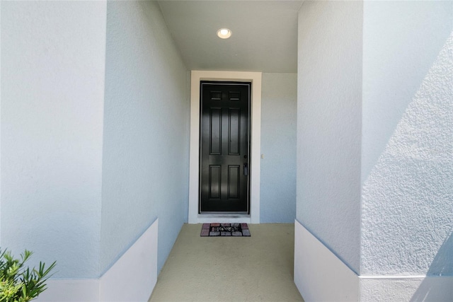 8595 Prairie Creek Dr, New Port Richey, FL 34655 - doorway to property featuring stucco siding