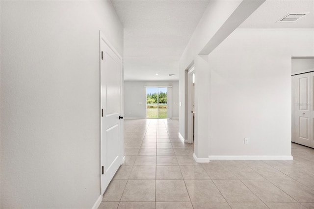 8595 Prairie Creek Dr, New Port Richey, FL 34655 - corridor with light tile patterned floors and baseboards