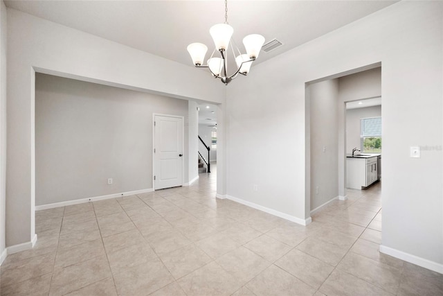 8595 Prairie Creek Dr, New Port Richey, FL 34655 - spare room with a chandelier, a sink, stairs, light tile patterned flooring, and baseboards