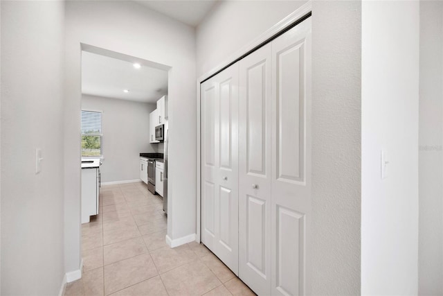 8595 Prairie Creek Dr, New Port Richey, FL 34655 - corridor featuring light tile patterned flooring, baseboards, and recessed lighting