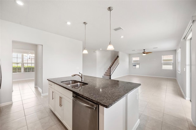 8595 Prairie Creek Dr, New Port Richey, FL 34655 - kitchen with a sink, dishwasher, light tile patterned floors, a ceiling fan, and dark stone counters
