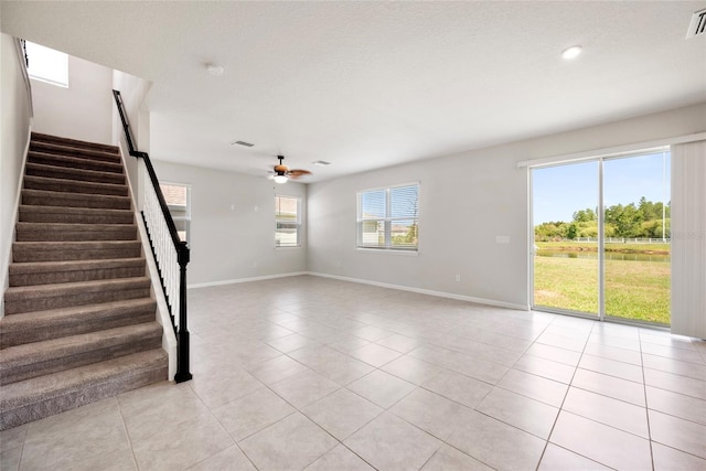 8595 Prairie Creek Dr, New Port Richey, FL 34655 - unfurnished living room with ceiling fan, stairway, baseboards, and recessed lighting
