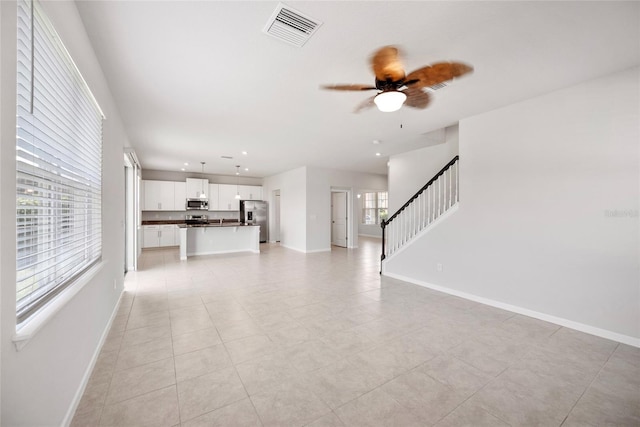 8595 Prairie Creek Dr, New Port Richey, FL 34655 - unfurnished living room featuring baseboards, stairway, ceiling fan, recessed lighting, and light tile patterned flooring