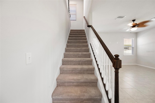 8595 Prairie Creek Dr, New Port Richey, FL 34655 - stairway featuring a ceiling fan, tile patterned floors, and baseboards