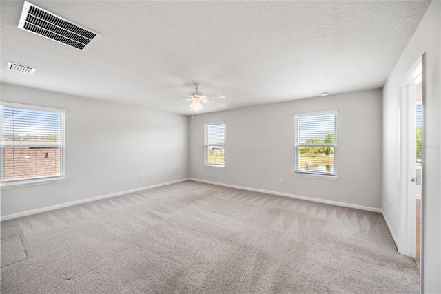 8595 Prairie Creek Dr, New Port Richey, FL 34655 - empty room featuring baseboards, ceiling fan, light carpet, and a textured ceiling
