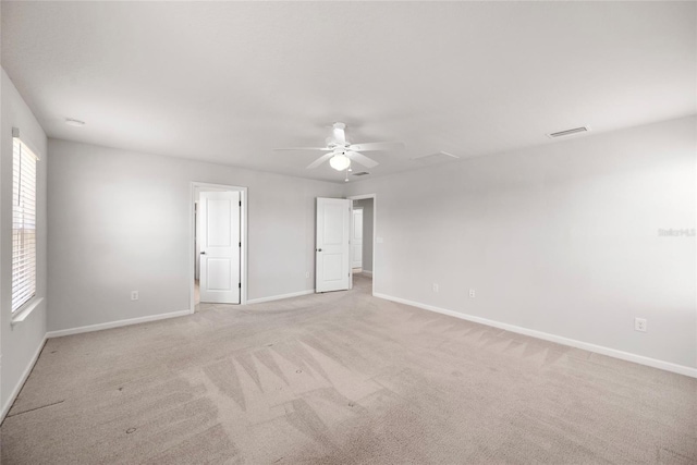 8595 Prairie Creek Dr, New Port Richey, FL 34655 - empty room with healthy amount of natural light, baseboards, ceiling fan, and light carpet