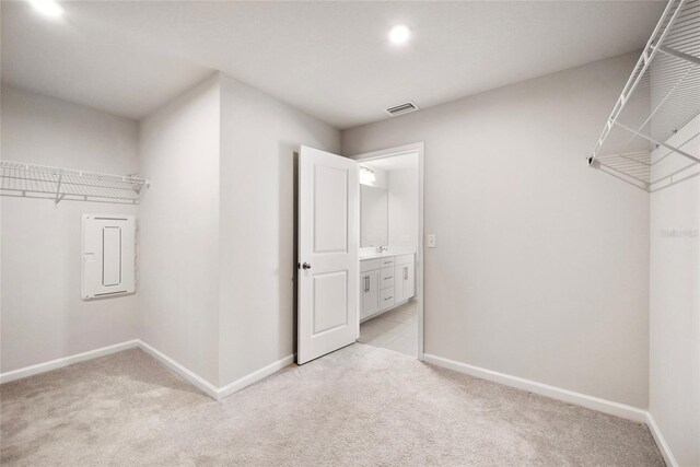 8595 Prairie Creek Dr, New Port Richey, FL 34655 - walk in closet featuring light colored carpet