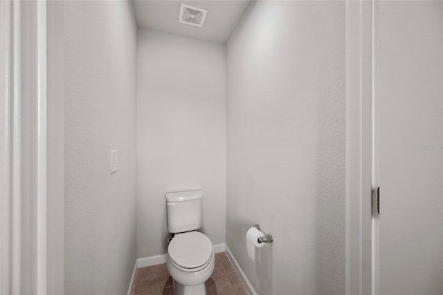 8595 Prairie Creek Dr, New Port Richey, FL 34655 - bathroom with tile patterned floors, toilet, and baseboards