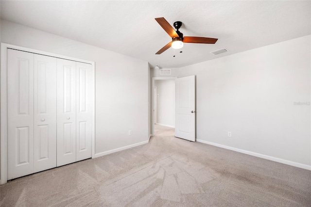 8595 Prairie Creek Dr, New Port Richey, FL 34655 - unfurnished bedroom featuring carpet flooring, baseboards, a closet, and a ceiling fan
