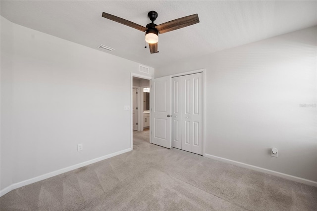 8595 Prairie Creek Dr, New Port Richey, FL 34655 - unfurnished bedroom featuring light colored carpet, baseboards, a closet, and ceiling fan
