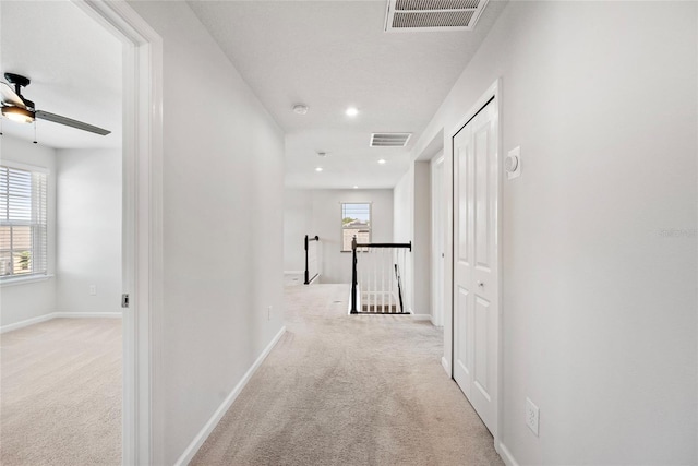 8595 Prairie Creek Dr, New Port Richey, FL 34655 - corridor with an upstairs landing, carpet, recessed lighting, and baseboards