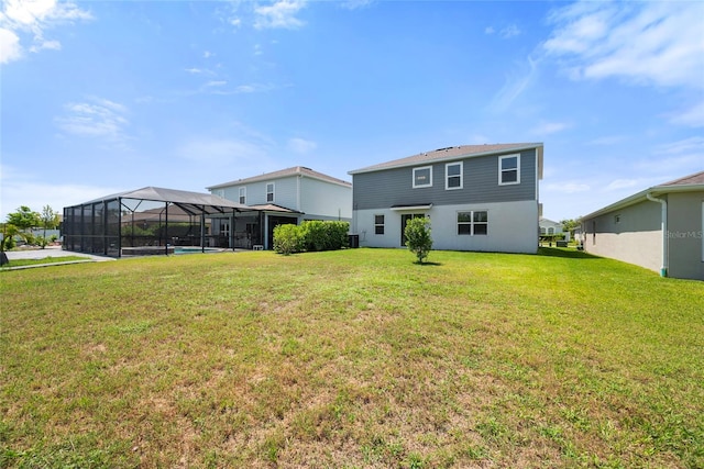 8595 Prairie Creek Dr, New Port Richey, FL 34655 - rear view of property with a lawn and a lanai