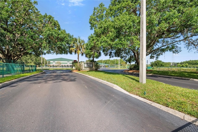 8595 Prairie Creek Dr, New Port Richey, FL 34655 - view of asphalt road featuring curbs