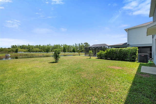 8595 Prairie Creek Dr, New Port Richey, FL 34655 - view of green lawn featuring cooling unit and a water view