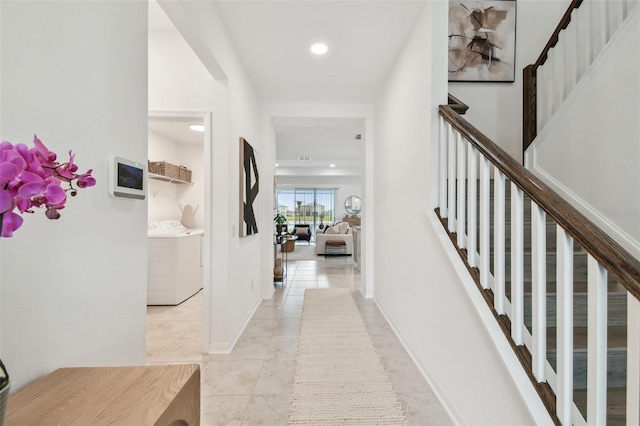 corridor with washing machine and dryer, stairway, light tile patterned floors, recessed lighting, and baseboards