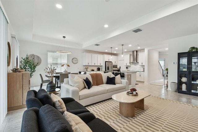 living room featuring recessed lighting, light tile patterned flooring, baseboards, and a raised ceiling