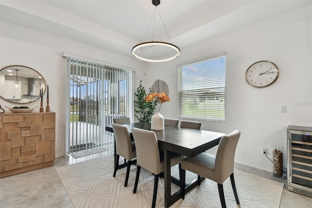 dining area featuring wine cooler, plenty of natural light, and baseboards