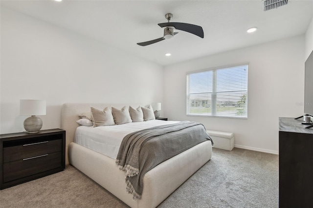 bedroom featuring light carpet, recessed lighting, baseboards, and ceiling fan