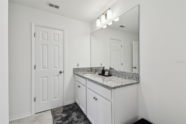 bathroom with vanity and baseboards
