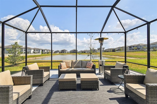 view of patio with a lanai, outdoor lounge area, a water view, and a residential view