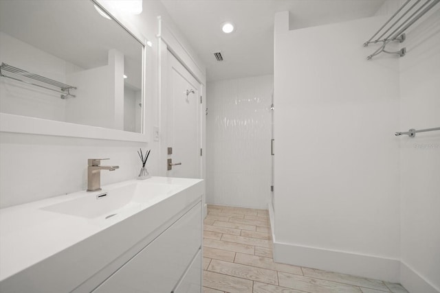 bathroom featuring recessed lighting, visible vents, and vanity
