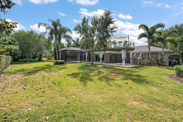 view of yard with stairs, a patio area, a lanai, and a deck