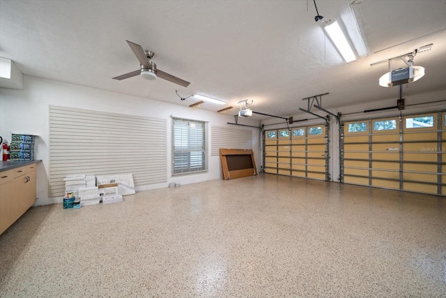 garage featuring a garage door opener and ceiling fan