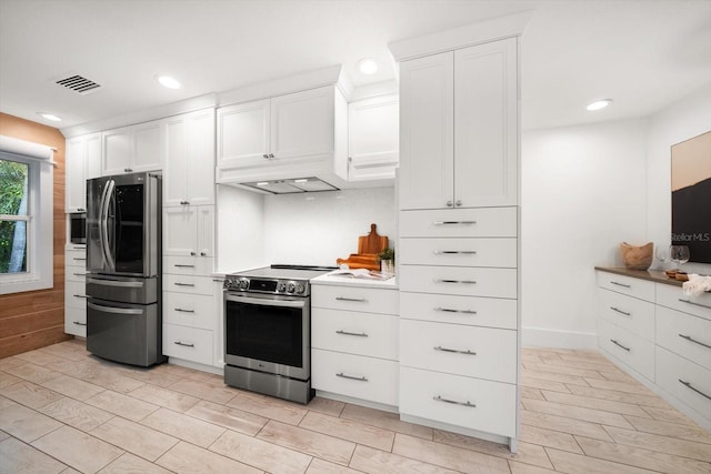 kitchen featuring stainless steel appliances, recessed lighting, white cabinetry, and visible vents