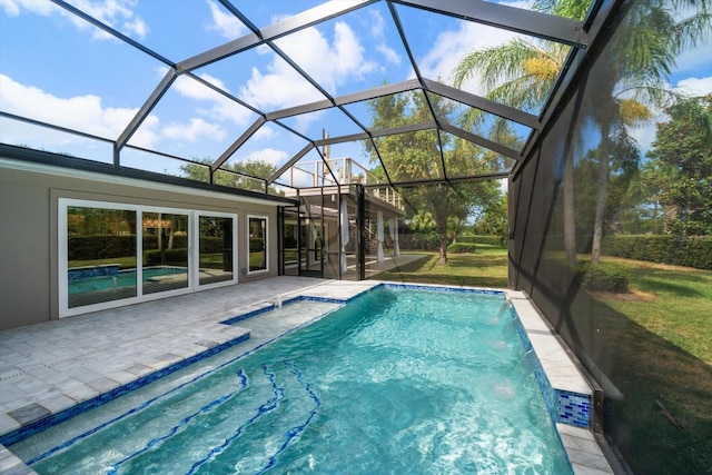 pool with a lawn, a lanai, and a patio area