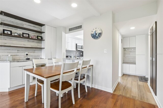 dining space with recessed lighting, visible vents, and light wood-type flooring