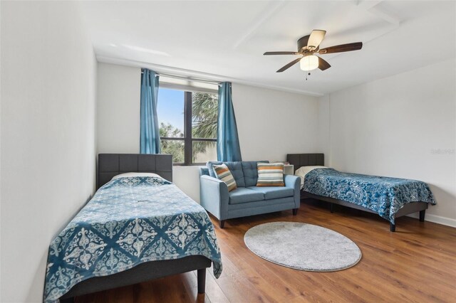 bedroom with a ceiling fan and wood finished floors