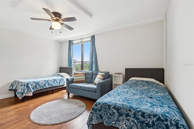bedroom with a ceiling fan and wood finished floors