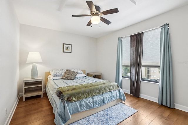 bedroom with baseboards, a ceiling fan, and hardwood / wood-style flooring