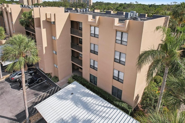 view of property featuring uncovered parking