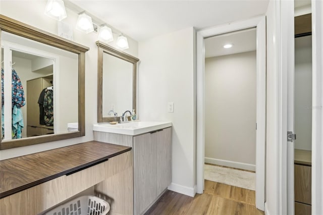 2615 Cove Cay Dr Unit 409, Clearwater, FL 33760 - bathroom with vanity, baseboards, and wood finished floors