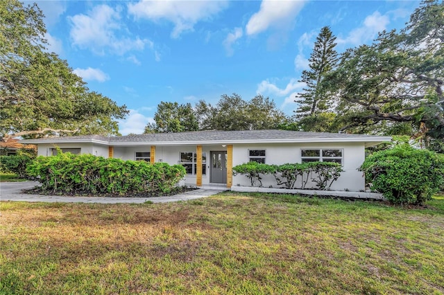 ranch-style home with a front lawn and stucco siding