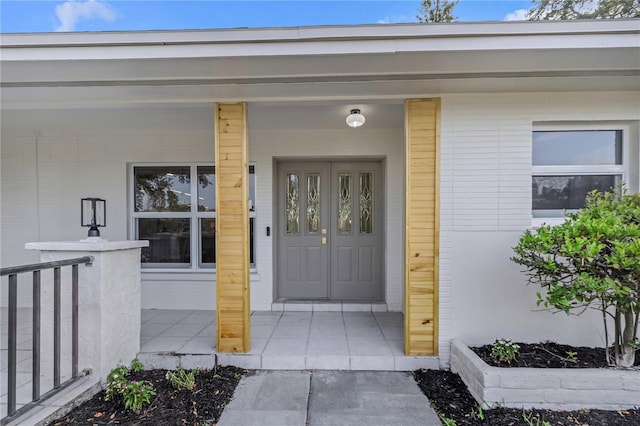 view of exterior entry with covered porch