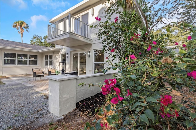 rear view of house with a balcony and a patio area