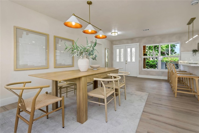 dining room featuring baseboards and wood finished floors