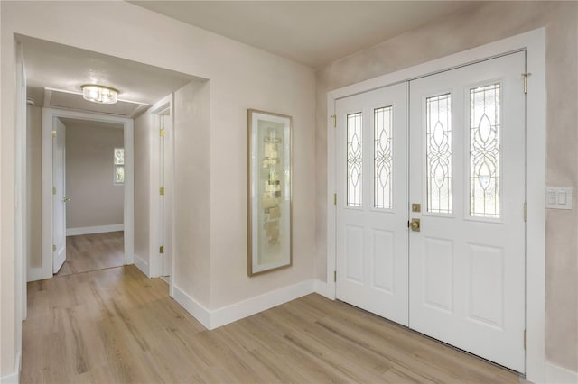 entryway featuring light wood-type flooring and baseboards