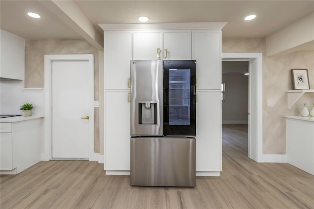 kitchen with stainless steel fridge with ice dispenser, light wood finished floors, white cabinetry, baseboards, and recessed lighting