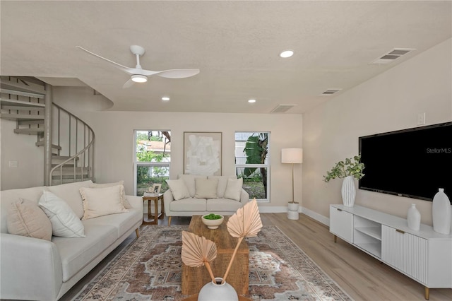 living room with light wood-style flooring, stairway, recessed lighting, baseboards, and a ceiling fan
