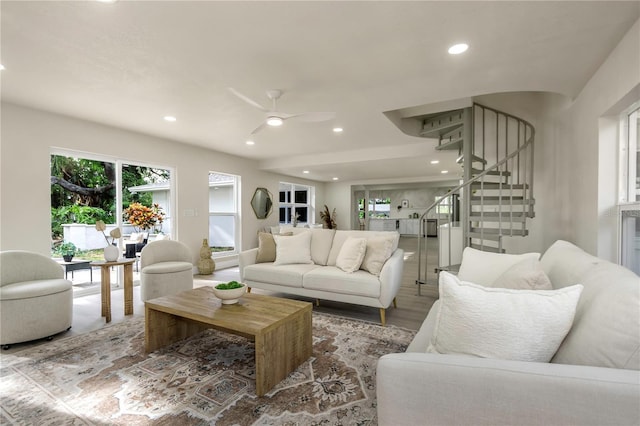 living room with stairway, recessed lighting, a ceiling fan, and wood finished floors